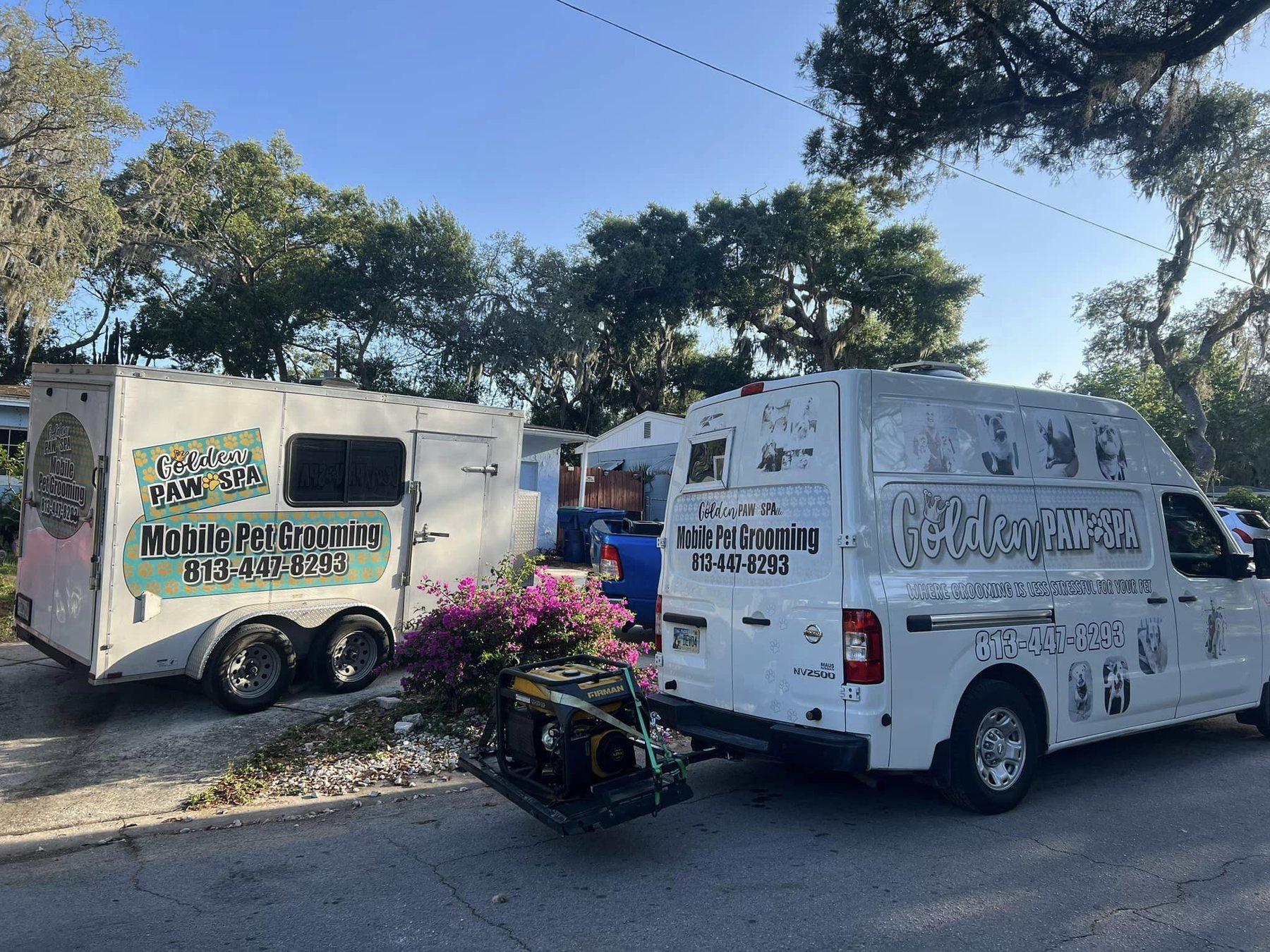 Golden Paw Spa mobile grooming van and trailer parked under Spanish moss, branded with the phone number 813-447-8293